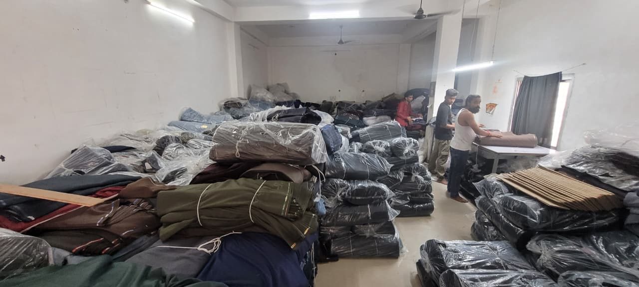 Fabric rolls and staff at the Shree Nakoda Impex manufacturing facility, Bhilwara